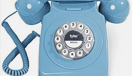 Blue vintage rotary dial telephone.